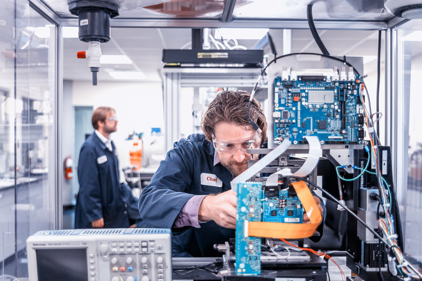 Engineer working with robotic arm corporate photography
